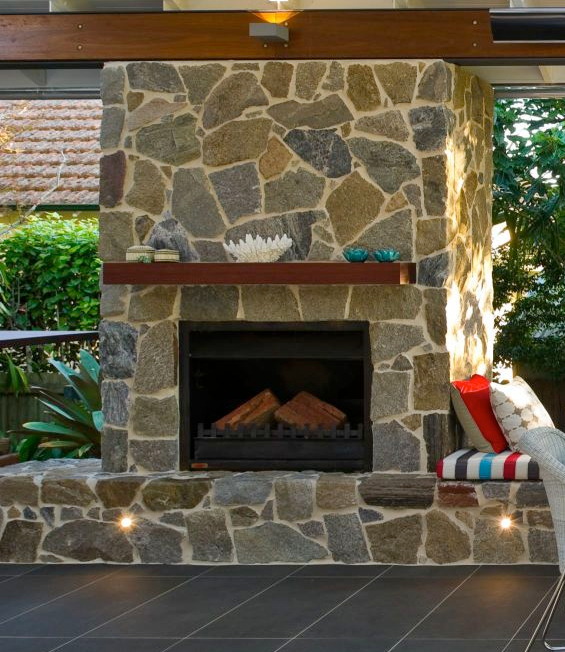 A stone fireplace and walls using Tilpa wall claddings and some furniture Exterior barbeque place