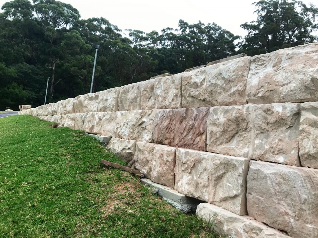 Australian sandstone logs used in a landscape project as retaining wall blocks
