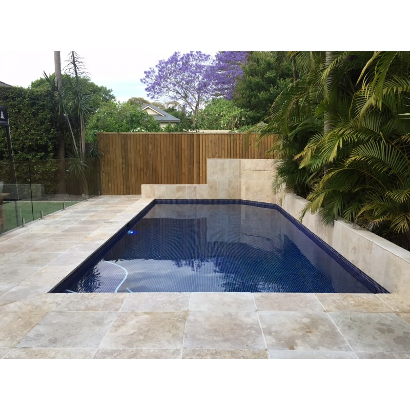 Travertine paver in residential swimming pool flooring