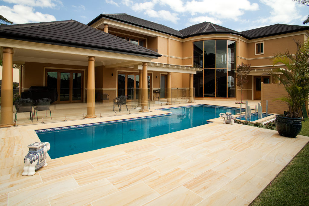 Teakwood-Sandstone-Honed-paver in a residential swimming pool floor project