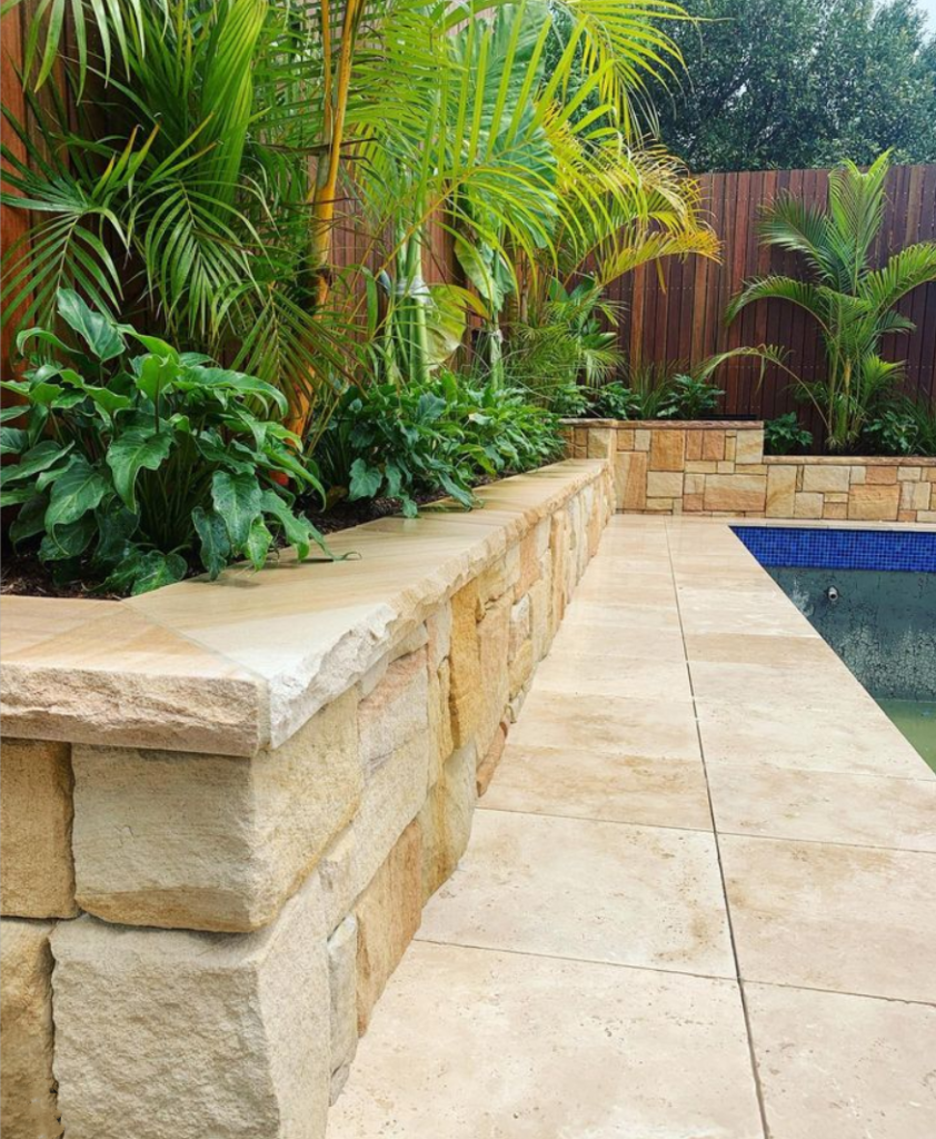 Colonial banded sandstone walling and travertine paver