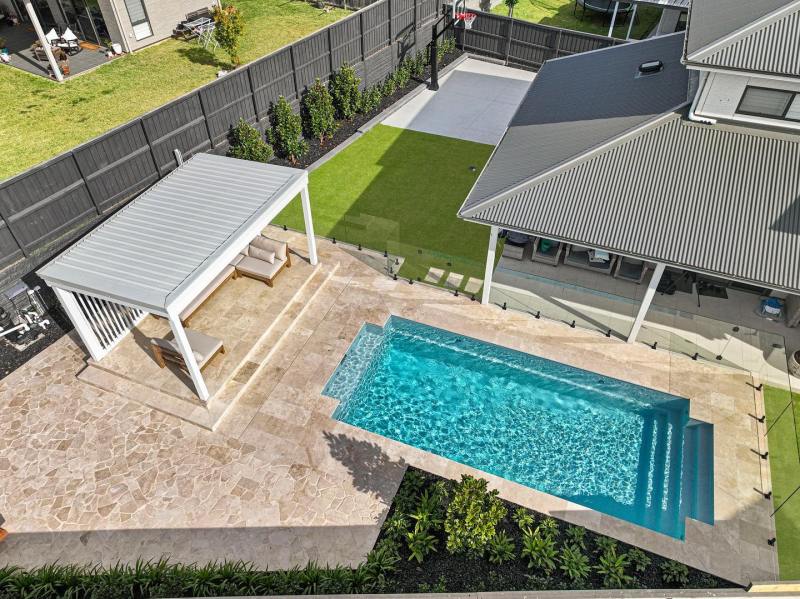 Classic travertine crazy paving and pool coping, landscaping project